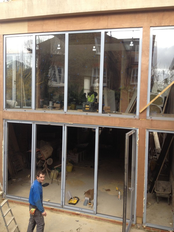 Aluminium bi-fold doors with two-storey glazing in Esher
