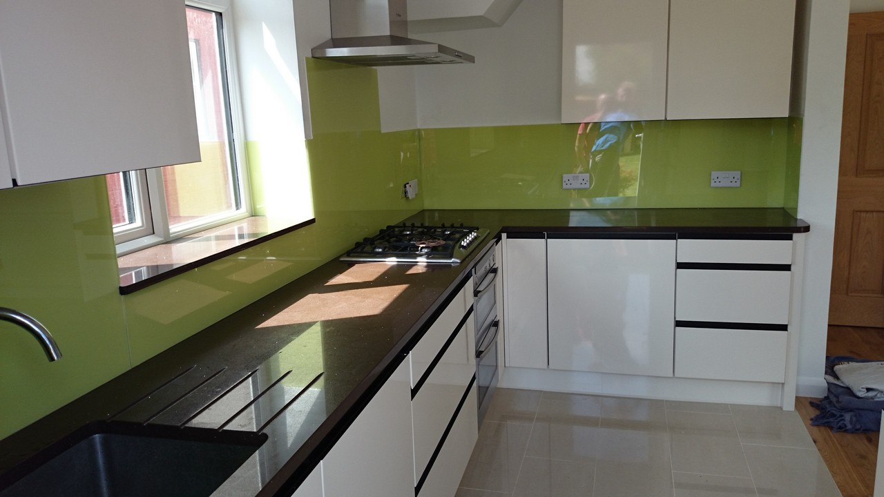 Lime green glass kitchen splashback installed by Esher glaziers