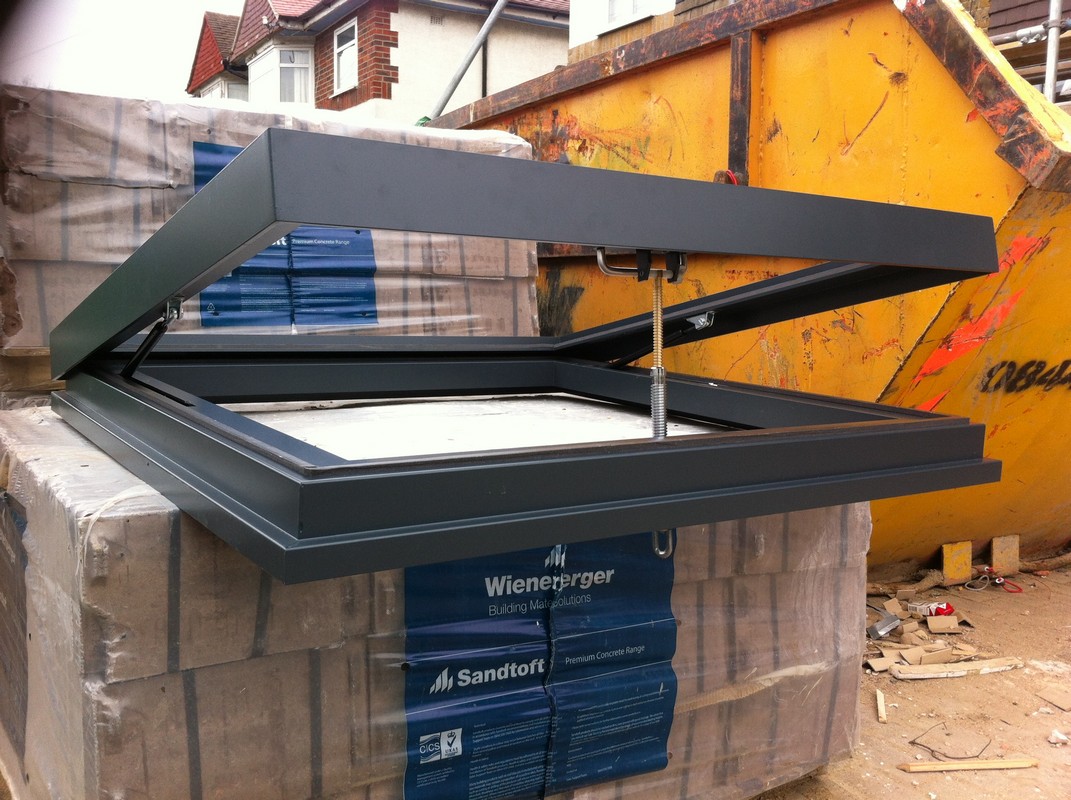 Opening flat roof skylight in anthracite grey installed in Esher