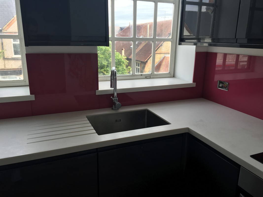 Deep plum coloured glass splashback in modern Esher kitchen